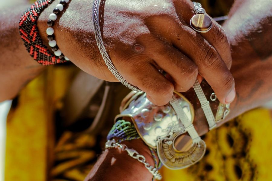 Close-up of a man's hands wearing rings and bracelets